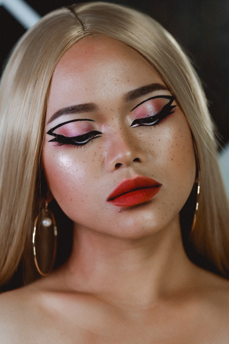 a woman with long blonde hair and red lipstick
